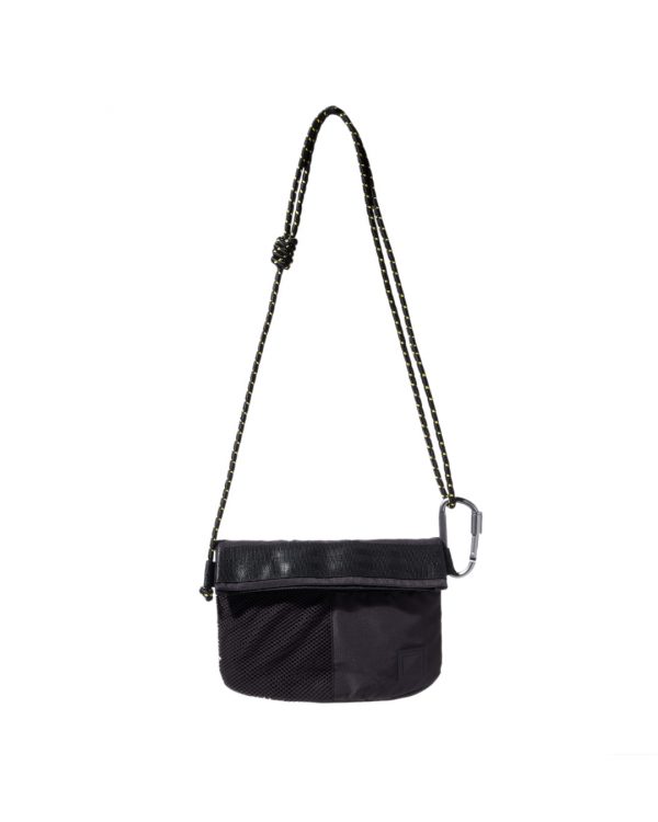 Straight front view of the black SYMA Chain highlighting its half-mesh front pocket, speckled paracord strap, and silver carabiner attachment. Compact sacoche bag.