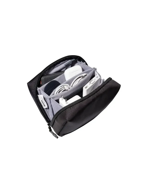 SYMA ARK travel tech organizer open displaying grey anti-scratch compartments filled with everyday carry chargers, cables, and earbuds