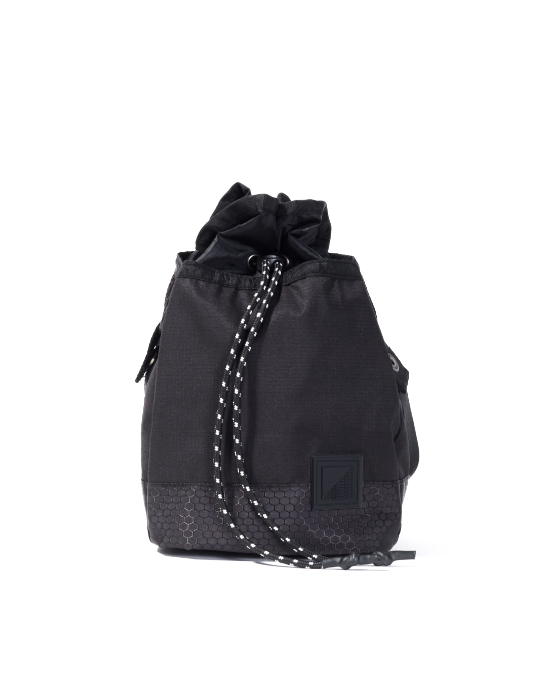 Straight front view of the black SYMA Sense Sling Bag highlighting its quick-access drawstring closure, paracord strings, and durable hexagon ripstop base. Minimalist drawstring sling bag.