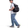Man in casual streetwear walking with black SYMA Hover Backpack on his back. 20L versatile daily backpack