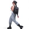 Woman in edgy urban streetwear carrying black SYMA Adore Backpack on shoulder. 11L compact everyday backpack