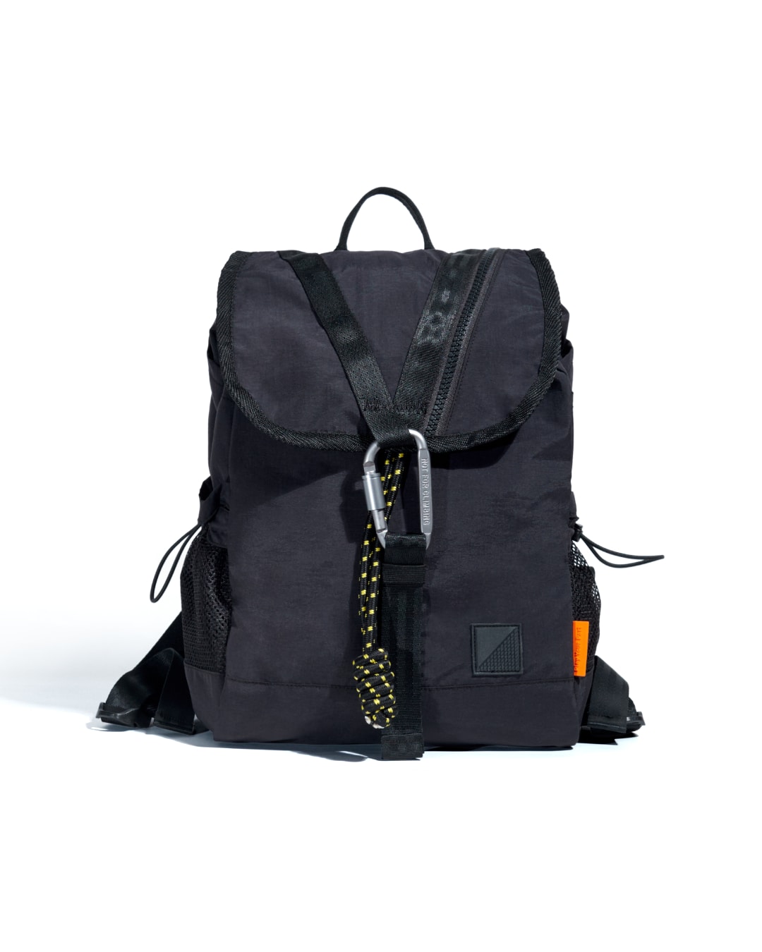Front view of black SYMA Adore Backpack highlighting V-shaped webbing and tactical carabiner. Compact everyday backpack
