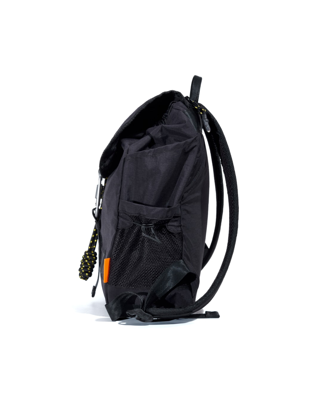 Left side profile view of black SYMA Adore Backpack highlighting slim structure and side mesh pocket. Compact everyday backpack