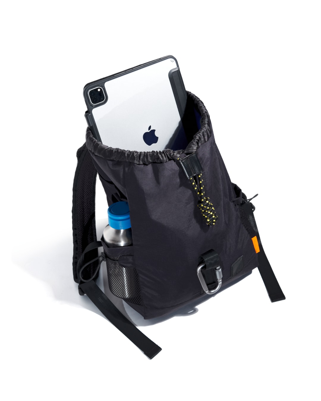 Interior open view of black SYMA Adore Backpack showing tablet inside main compartment and water bottle in side mesh pocket. Compact everyday backpack