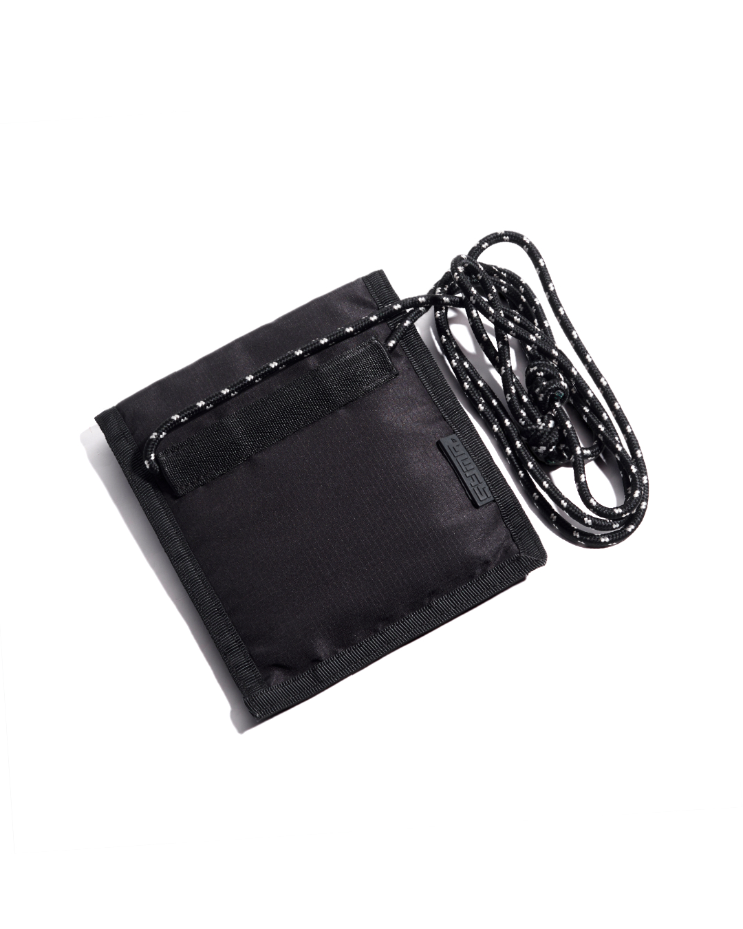 Back exterior view of the closed black SYMA Arrival compact travel wallet, featuring a 2cm nylon webbing loop and attached paracord strap