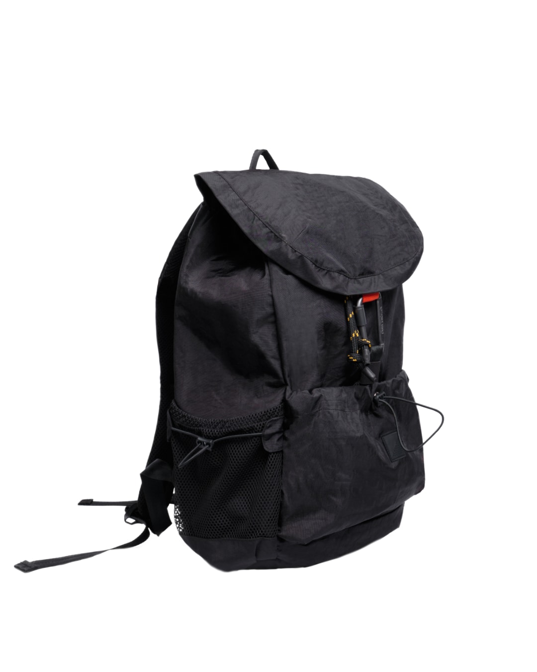 Angled view of black SYMA Outrun Backpack highlighting side mesh pocket and flap structure. Versatile everyday backpack