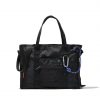 Front view of black SYMA Miles Tote Bag highlighting front mesh pocket and tactical carabiner with blue paracord. Versatile work tote bag