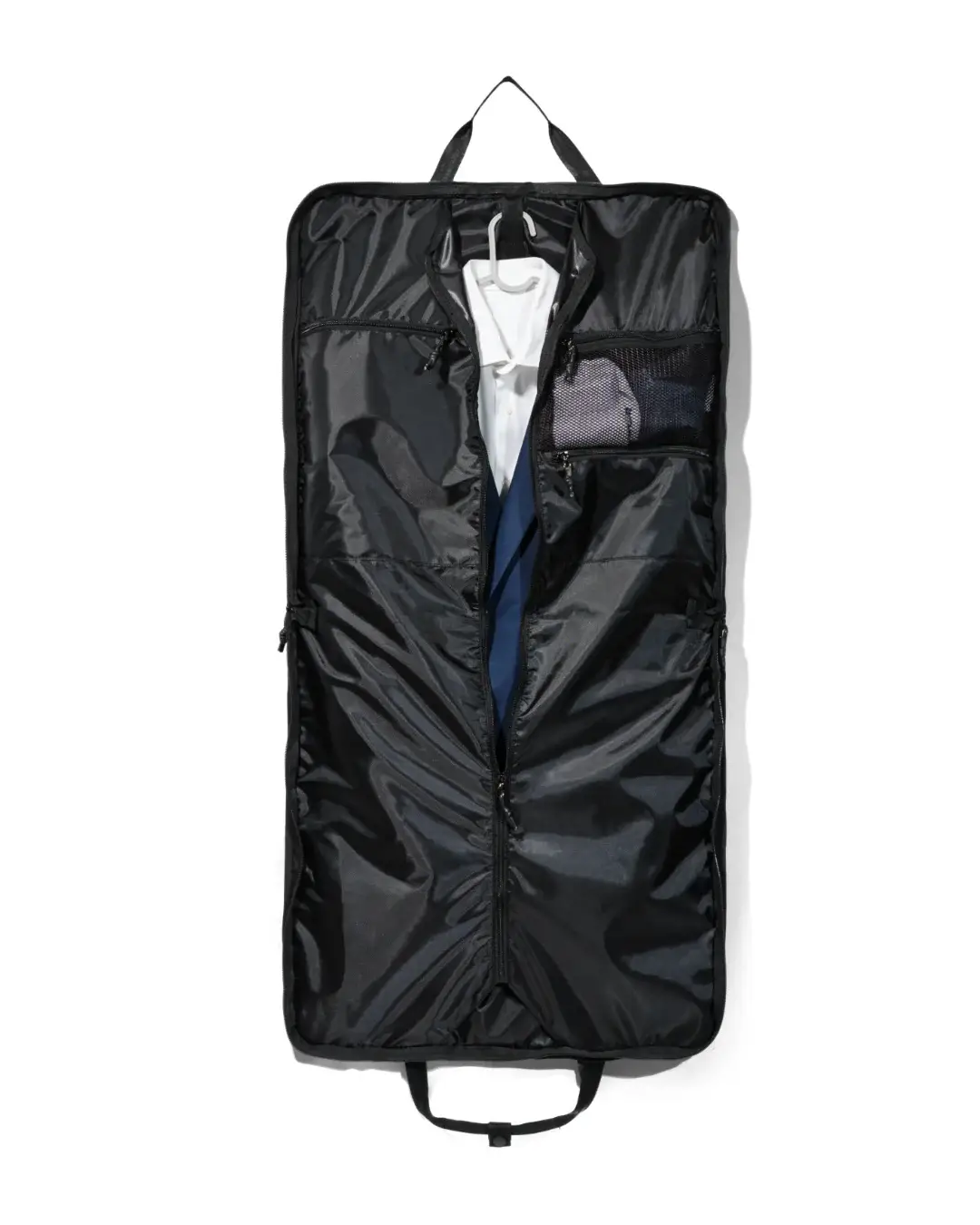 Straight interior view of the fully unzipped black SYMA Motion revealing a white shirt and navy suit jacket on a hanger, alongside an internal mesh pocket. Travel garment bag.