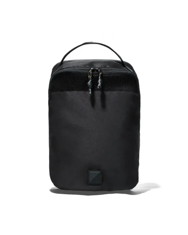 Straight front view of black SYMA Cubic highlighting its symmetrical upper mesh ventilation panel, dual zippers, and structured profile. Ventilated travel shoe bag.