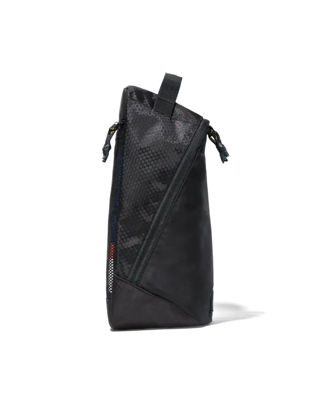 Side profile view of black SYMA Cubic highlighting its space-saving tapered structure and slim depth. Ventilated travel shoe bag.
