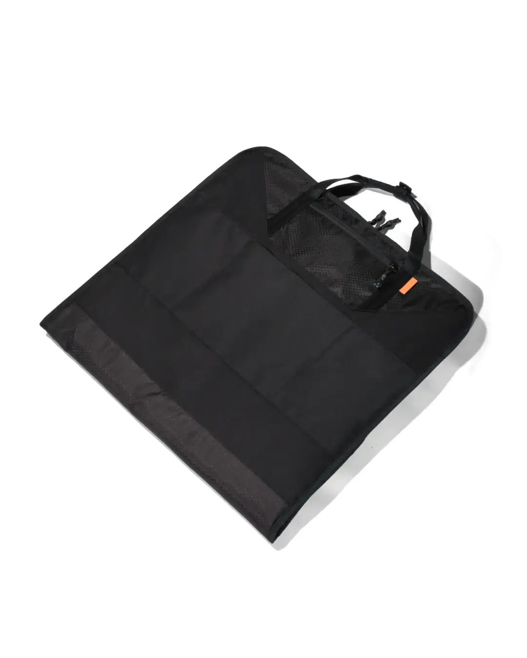 Angled rear view of the folded black SYMA Motion laid flat, highlighting its built-in luggage slip-through sleeve for easy airport transit. Travel garment bag.