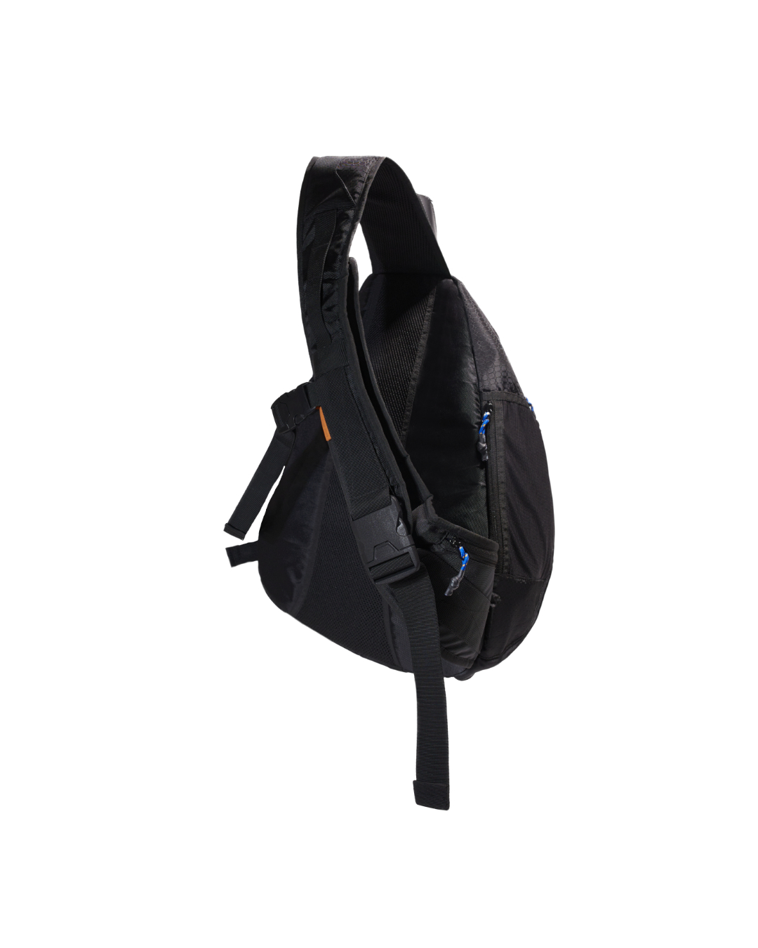 Angled suspended rear-side view of the black SYMA Symmetry Crossbody Bag highlighting its wide strap with a heavy-duty release buckle, breathable mesh back panel, and hexagon ripstop accents. Large techwear crossbody bag.