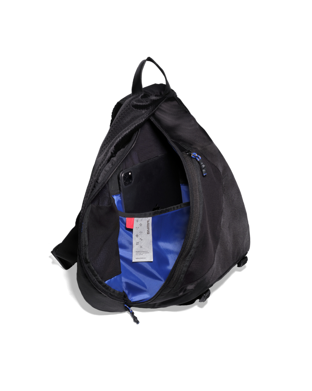 High-angle open interior view of the black SYMA Symmetry Crossbody Bag demonstrating its internal device sleeve holding a black tablet against the high-contrast blue lining. Large techwear crossbody bag.