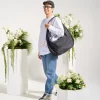 Man wearing SYMA Fable Sling Bag Black on shoulder. Oversized urban commuter messenger bag