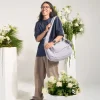 Man wearing SYMA Fable Sling Bag Light Grey on shoulder. 16L minimalist tech messenger