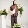 Woman wearing SYMA Fable Sling Bag Light Cream on shoulder. 16L minimalist everyday sling bag