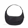 Front view of SYMA Fable Sling Bag Black showing quick access flap pocket. 16L oversized crossbody bag