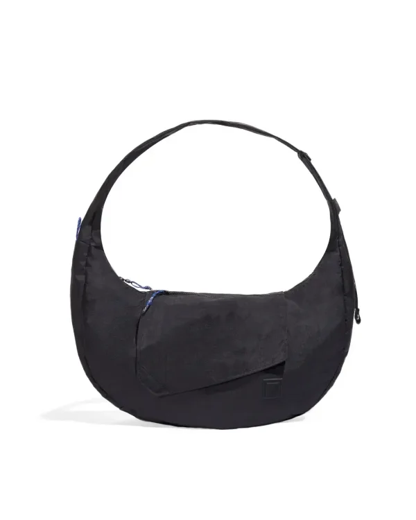 Front view of SYMA Fable Sling Bag Black showing quick access flap pocket. 16L oversized crossbody bag