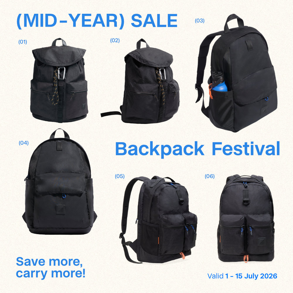 Mobile promotional banner for the SYMA (MID-YEAR) SALE Backpack Festival, displaying six numbered black urban backpacks. The layout includes bold blue text reading '(MID-YEAR) SALE' and 'Backpack Festival', the slogan 'Save more, carry more!', and the promotional dates 'Valid 1 - 15 July 2026'.