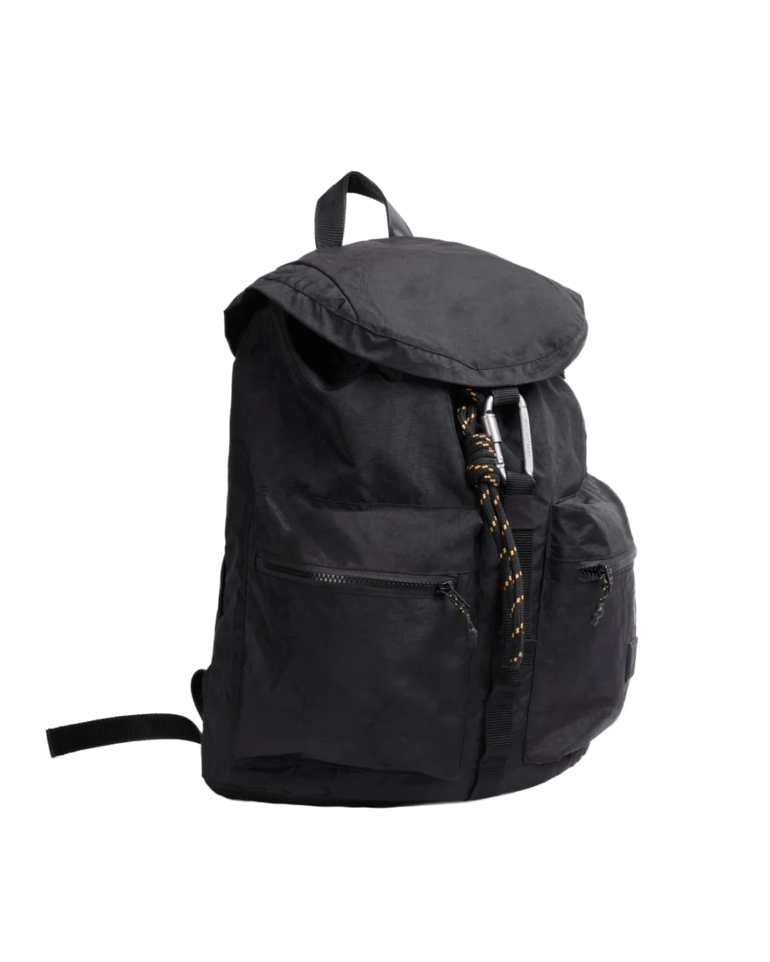 Angled view of black SYMA Hover Backpack highlighting classic flap closure, tactical carabiner, and dual front pockets. Versatile daily backpack