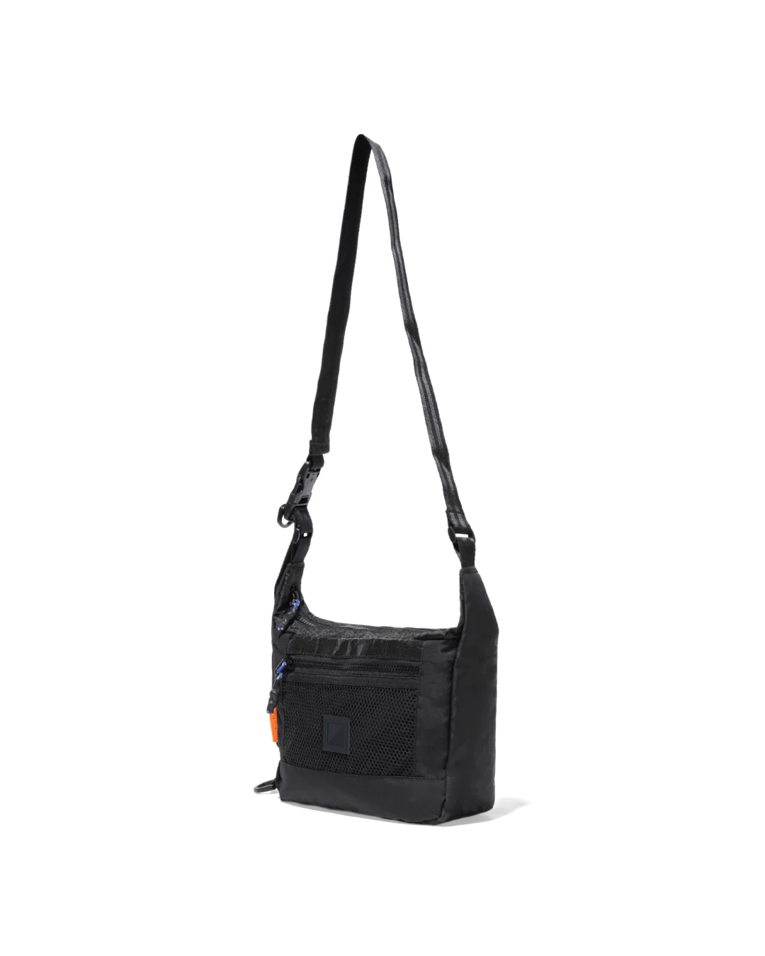 Angled suspended view of the black SYMA Strings Sling Bag highlighting its structured 9cm depth profile, glossy PE Tarpaulin top panel, and front mesh pocket. Small urban crossbody bag.
