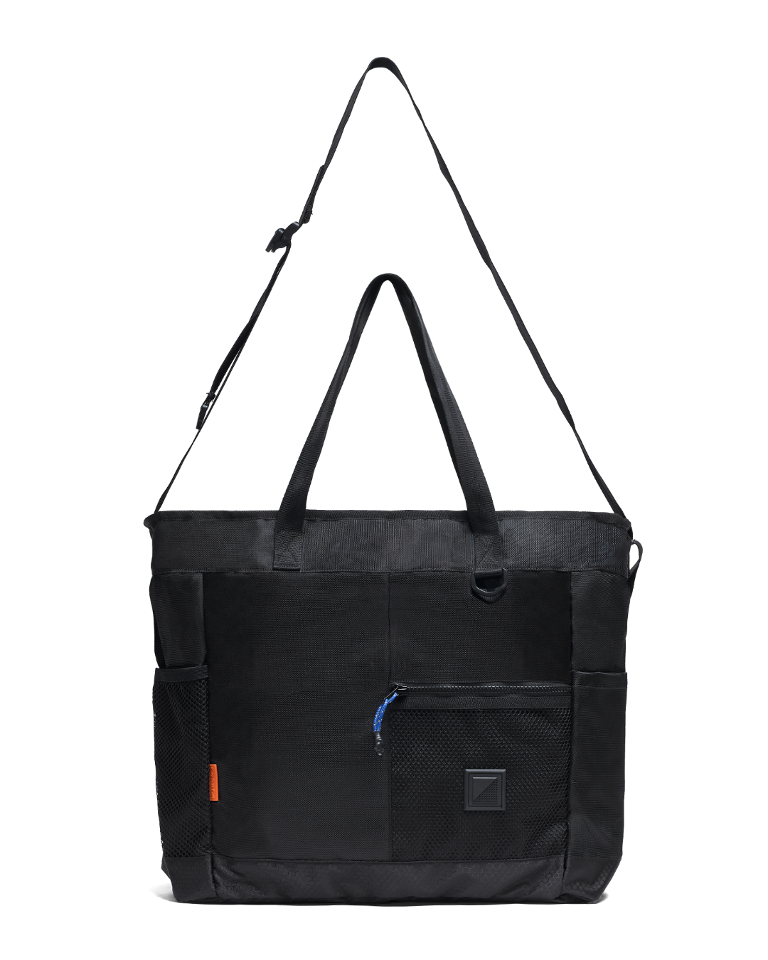 Straight front studio view of the black SYMA Bridge Tote Bag with its adjustable crossbody strap fully extended upwards, showcasing dual top carry handles, side mesh pockets, and a front zippered compartment with a blue paracord puller